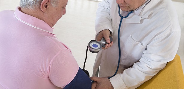 doctor checking blood pressure of his patient fat man